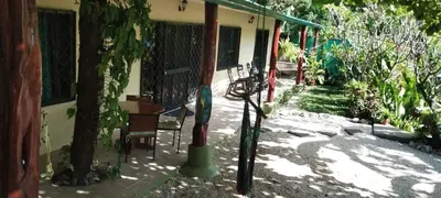 two baseball bats leaning against a house at Aloha Surf Nosara - Casa 'Ohana in Nosara