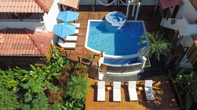 an overhead view of a swimming pool with chairs and umbrellas at Casa Marbella in Santa Teresa Beach