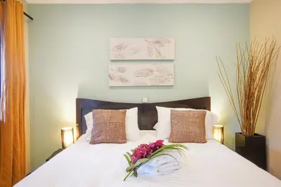 a bedroom with a bed with flowers on it at Casa Marbella in Santa Teresa Beach