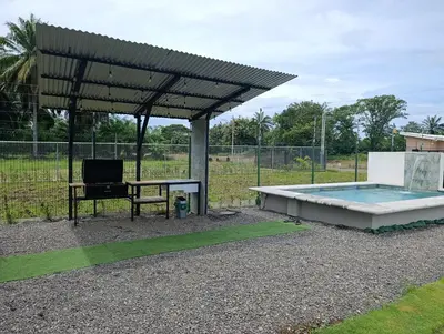 a pavilion with a table and a bench and a pool at Maracuyá Garden Stanza 2 in Parrita