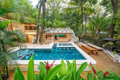 a swimming pool in front of a house at Toro by Dreamcatcher in Santa Teresa Beach