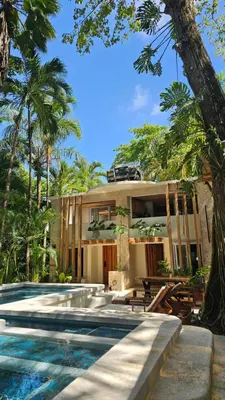 a house with a swimming pool in front of a house at Toro by Dreamcatcher in Santa Teresa Beach