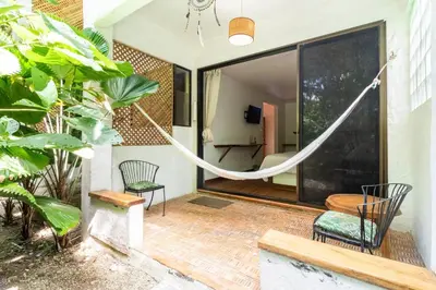 a house with a hammock in the middle of a patio at Toro by Dreamcatcher in Santa Teresa Beach