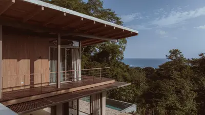 a house with a balcony with a view of the ocean at Casa Solomia Luxury Oceanview 5 min to the Beach in Mal País