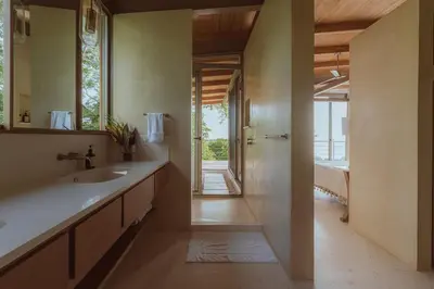 a bathroom with a sink and a mirror at Casa Solomia Luxury Oceanview 5 min to the Beach in Mal País