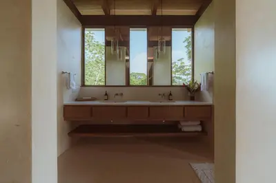 a bathroom with a sink and a mirror at Casa Solomia Luxury Oceanview 5 min to the Beach in Mal País