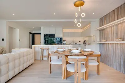 a kitchen and dining room with a table and a couch at Flamingo Marina Private Beachfront Escape in Playa Flamingo