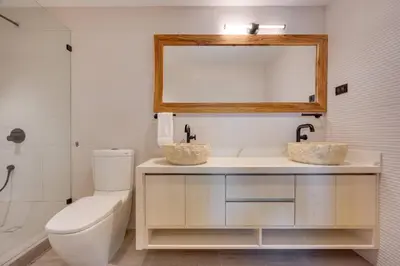 a bathroom with a toilet and a sink and a mirror at Flamingo Marina Private Beachfront Escape in Playa Flamingo