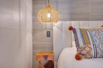 a bedroom with a bed and a pendant light at Flamingo Marina Private Beachfront Escape in Playa Flamingo