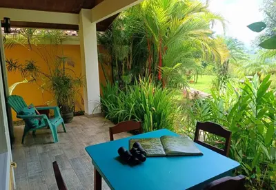a blue table and chairs on a patio at Villa Colibri at LakeGardens in Nuevo Arenal