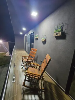 three wooden chairs sitting on top of a balcony at Home Pura Vida With Cuban Flavor
