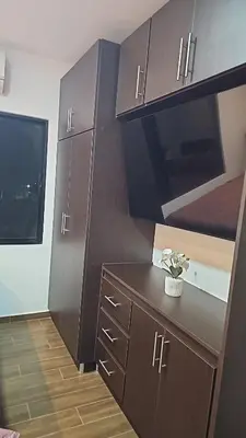 a kitchen with brown cabinets and a black counter at Home Pura Vida With Cuban Flavor