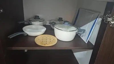 a shelf with two pots and a bowl on it at Home Pura Vida With Cuban Flavor