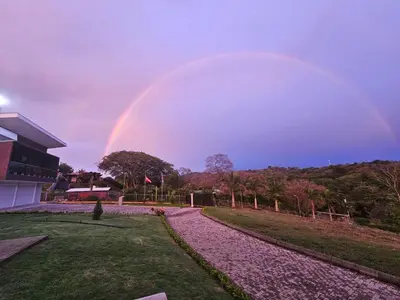 a rainbow in the sky over a house at Home Pura Vida With Cuban Flavor