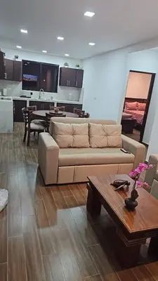 a living room with a couch and a table at Home Pura Vida With Cuban Flavor