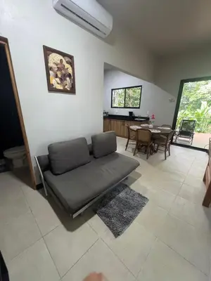 a living room with a couch and a table at Casa Selva Pacifico in Quebrada Ganado