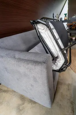 a gray couch with a bag on top of it at Cozy Volcano View Stay Brand New & Hot Tub in Fortuna