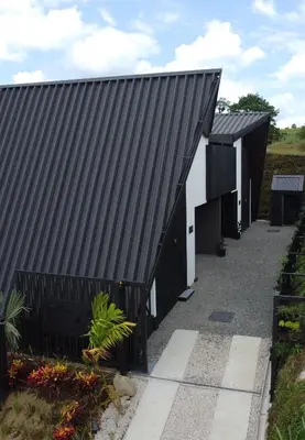a black and white house with a black roof at Charming Cabin in La Fortuna wHot Tub Brand new! in Fortuna
