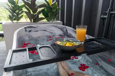 a tray with a bowl of fruit and a glass of orange juice at Charming Cabin in La Fortuna wHot Tub Brand new! in Fortuna