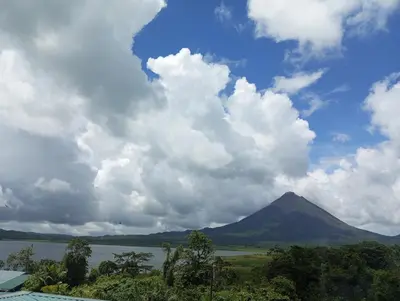 a view of a mountain and a lake and clouds at Casa Lago in El Castillo de La Fortuna