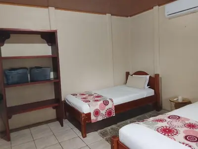 a small room with two beds at Casa Lago in El Castillo de La Fortuna
