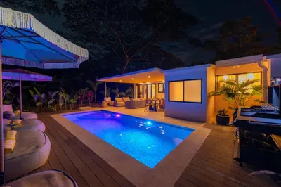 a house with a swimming pool at night at Casa Contento - luxury 3bdr home near Santa Teresa in Boca de Ario