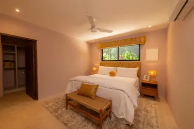 a bedroom with a large bed and a window at Casa Contento - luxury 3bdr home near Santa Teresa in Boca de Ario