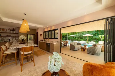 an open kitchen and living room with a dining room at Casa Contento - luxury 3bdr home near Santa Teresa in Boca de Ario