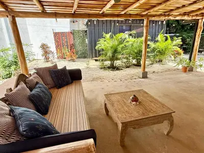a living room with a couch and a coffee table at Passion For Surfing Apt Playa Guiones in Playa Guiones