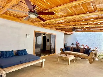a living room with a ceiling fan and a couch at Passion For Surfing Apt Playa Guiones in Playa Guiones