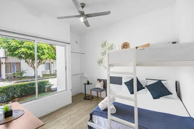 a bedroom with a bunk bed and a window at Jacó Condo 2 BR, Pool & families in Jacó