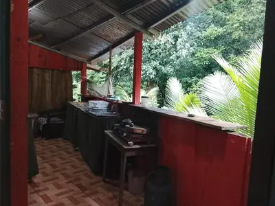 an outdoor kitchen with a counter and a table at Casa Victoria in Ojochal