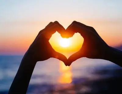 a pair of hands making a heart shaped at Casa Plumeria-Aloha Surf Nosara in Nosara