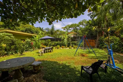 a park with a table and chairs and a swing at Casa Mango- family friendly 2 Bedroom, 2 Bath in Nosara