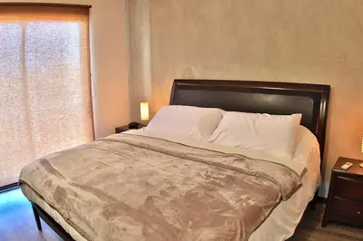 a large bed in a bedroom with a window at The Luxury Condo at Reserva Conchal, Great Beach in Playa Conchal