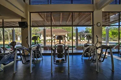 a gym with a bunch of exercise equipment in it at The Luxury Condo at Reserva Conchal, Great Beach in Playa Conchal