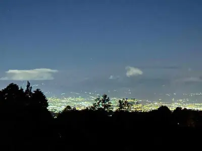 a view of a city at night with lights at Poás Natural in Alajuela City