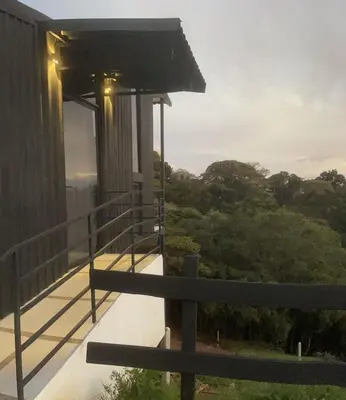 a balcony of a house with a view of trees at Poás Natural in Alajuela City