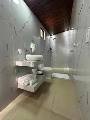 a bathroom with a toilet and a sink and a shower at Poás Natural in Alajuela City