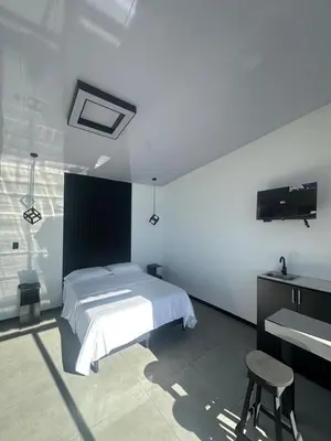 a white bedroom with a bed and a sink at Poás Natural in Alajuela City