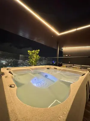 a jacuzzi tub in a hotel room at night at Edificio SER Barrio Escalante in San José