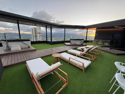 a patio with lounge chairs and tables on a building at Edificio SER Barrio Escalante in San José