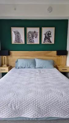 a bedroom with a bed with four pictures on the wall at Edificio SER Barrio Escalante in San José