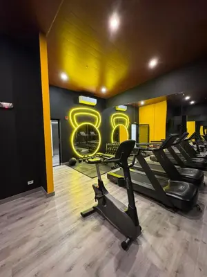 a gym with treadmills and a sign that reads at Edificio SER Barrio Escalante in San José