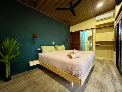 a bedroom with a large bed in a room at Jungle House with Private Jacuzzi in Uvita