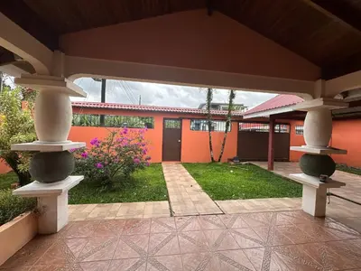 an outside view of a house with a patio at Casa Vista al Volcan, La Fortuna in Fortuna