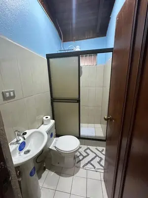 a bathroom with a toilet and a sink at Casa Vista al Volcan, La Fortuna in Fortuna