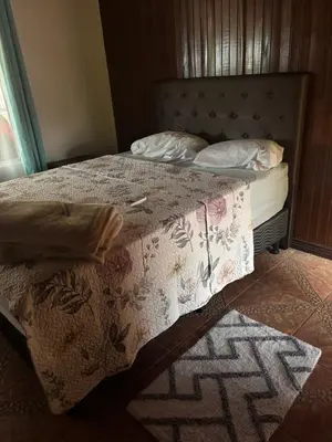 a bedroom with a bed with a blanket and pillows at Casa Vista al Volcan, La Fortuna in Fortuna