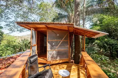 a tree house with a wrap around porch at Samara Tarantela, Treehouse in Sámara