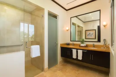 a bathroom with a shower and a sink and a mirror at El Sueño in Nacascolo